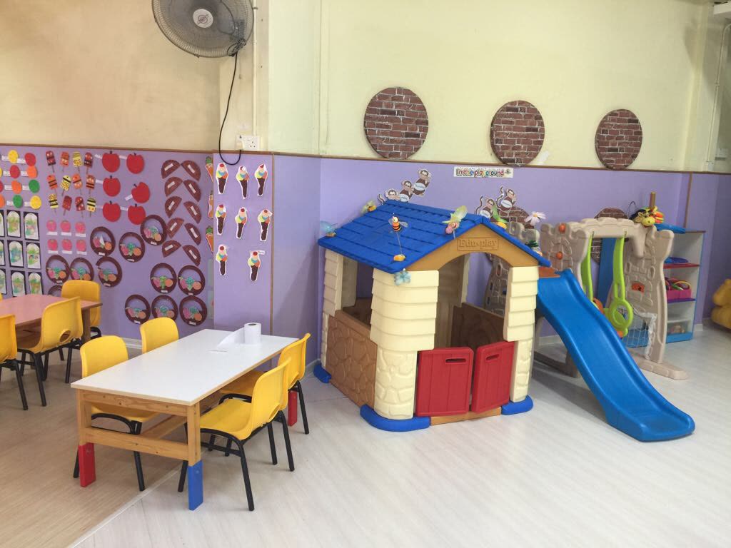 Playhouse and slide in our playgroup room